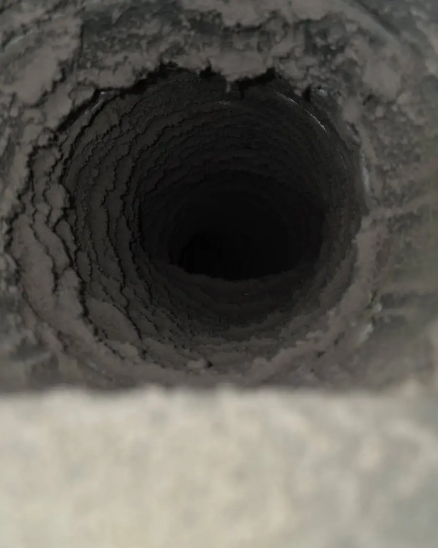 Flex duct interior coated in dust and debris before cleaning