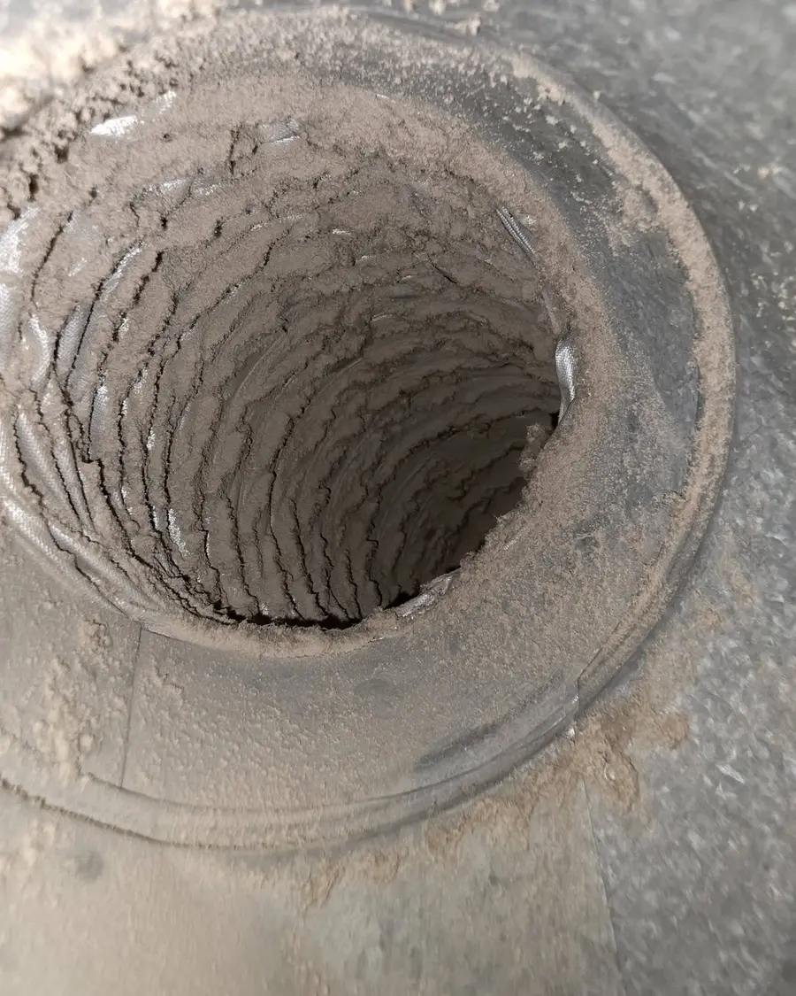 Dust-caked duct before cleaning
