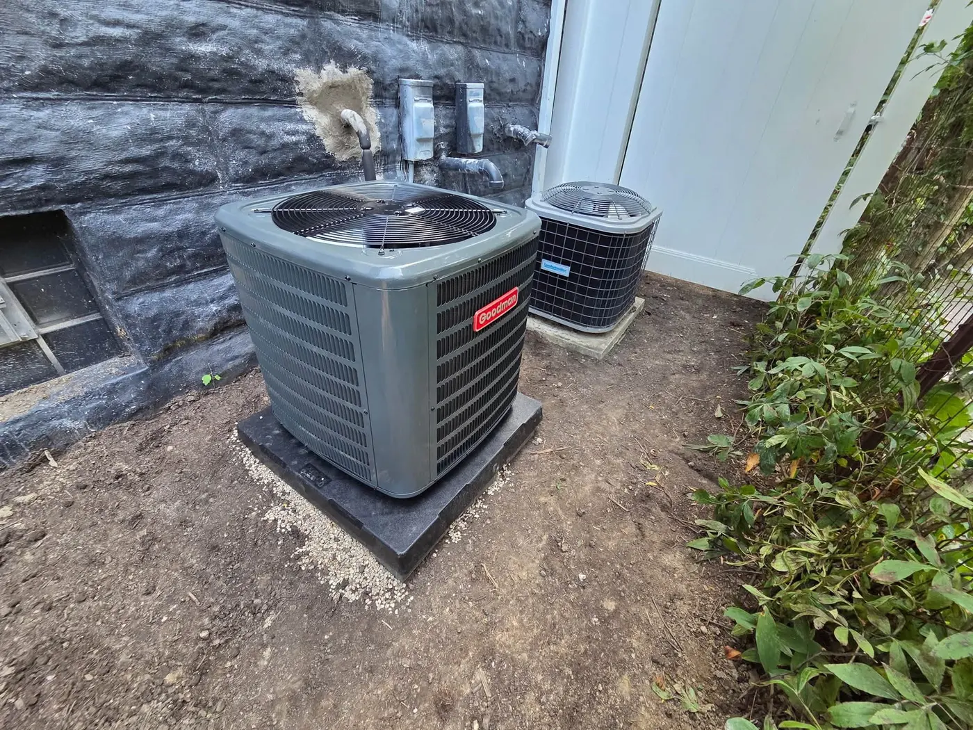New Goodman air conditioner condenser installed beside a Fox Valley home