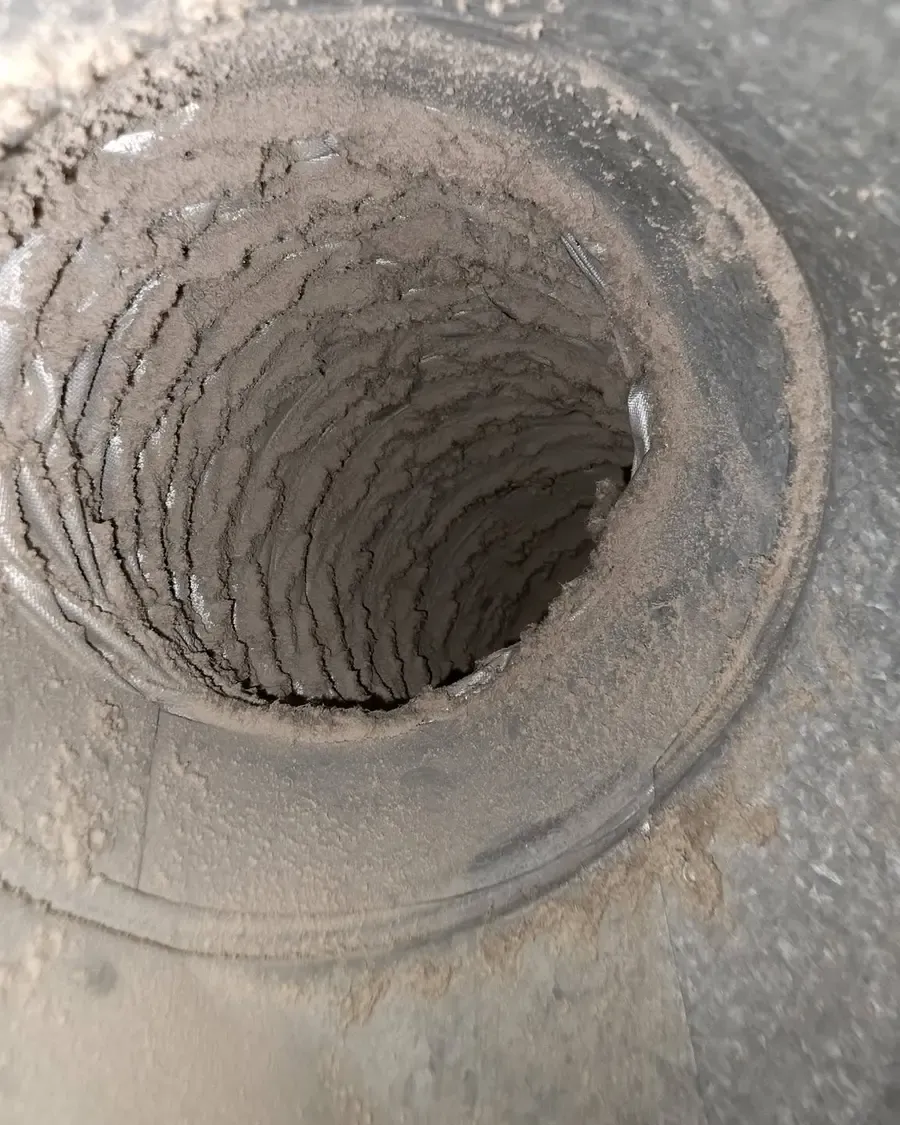 Dust-caked duct interior before cleaning