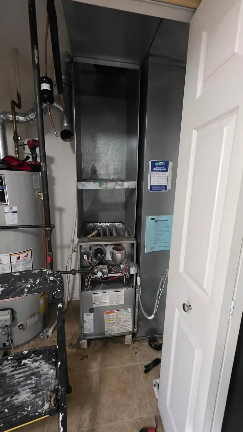 Furnace opened for inspection in a Fox Valley utility closet during fall maintenance